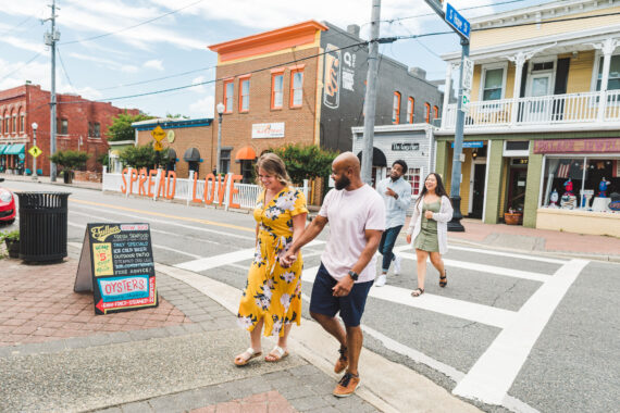 Two couples walking across a street in a picturesque downtown